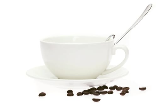 cup and saucer and coffee beans isolated on white
