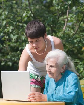 Grandmother and granddaughter with laptop
