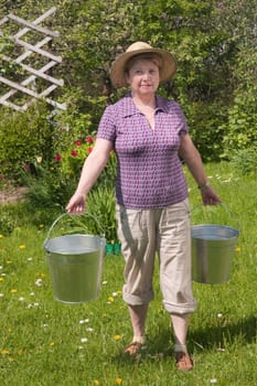 The rural woman with a bucket in hands