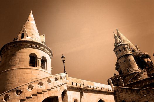 The great tower of Fishermen's Bastion on the castle hill of Budapest in sepia