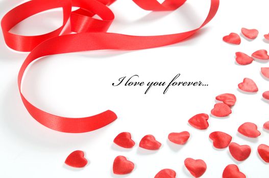Small red hearts and ribbon on white background. Composition for themes like love, valentine's day, holidays with space for your text