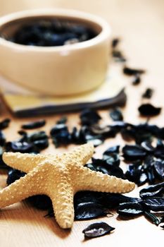 Spa flower petals in bowl and starfish