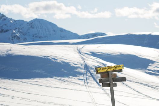 The signpost in the snowy mountains scenery