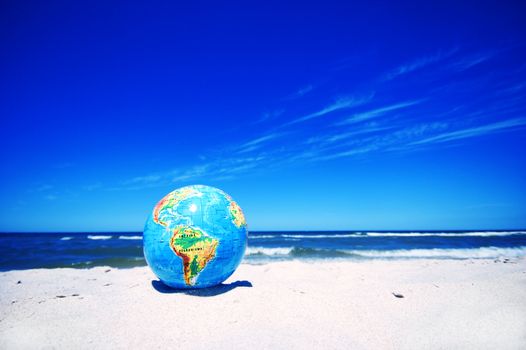 Earth globe on the beach. Ideal for Earth protection concepts, recycling, world issues, enviroment themes