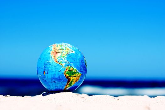 Earth globe on the beach. Ideal for Earth protection concepts, recycling, world issues, enviroment themes