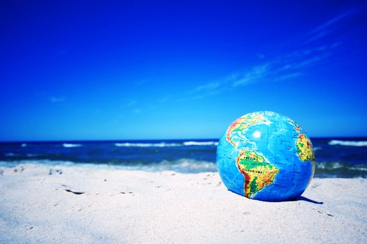 Earth globe on the beach. Ideal for Earth protection concepts, recycling, world issues, enviroment themes