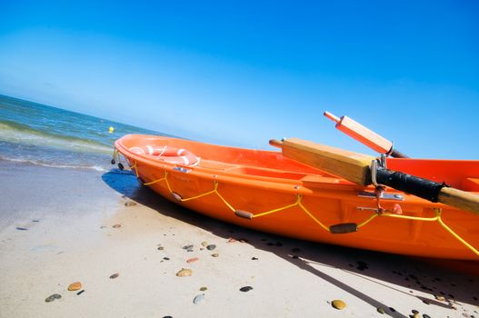 Orange rescue boat by the sea