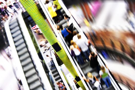 Shopping abstract. People rush on escalator motion blurred