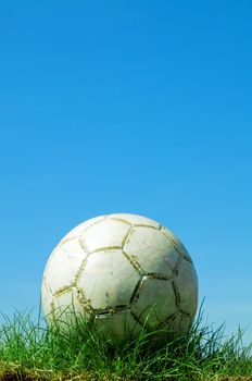 Soccer ball standing on grass