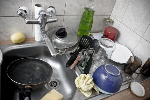 Ordinary sink full of dirty dishes