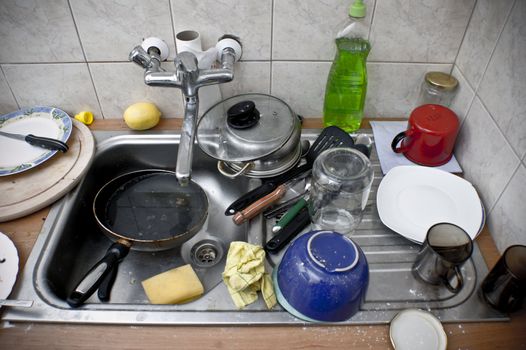 Ordinary sink full of dirty dishes