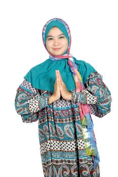 a beautiful muslim woman greetings with his palms pressed isolated on white background