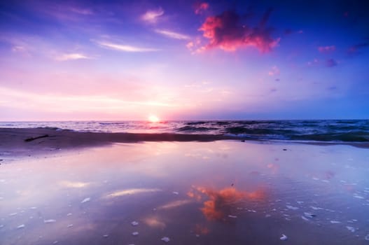 Beautiful sea sunrise. Colorful sky and water reflection