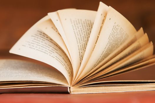 Open book in retro style on wooden background. Education concepts
