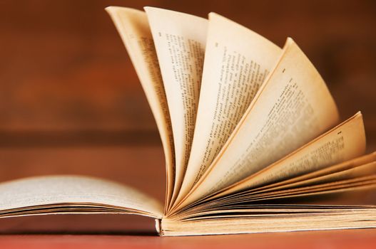 Open book in retro style on wooden background. Education concepts