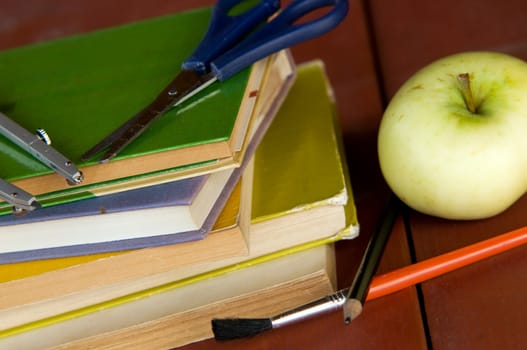 Pile of books, apple and school equipment. Education concept, back to school.