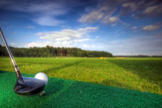Playing golf. Golf club and ball. Preparing to shot