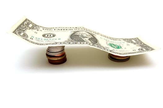 One Dollar Bill on coins weight isolated on white