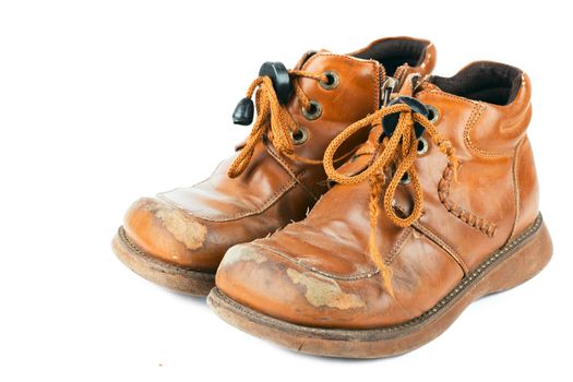 Child's old shoes with laces over white background