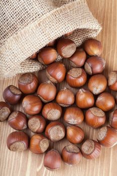 Closeup view of hazelnuts on a wooden table