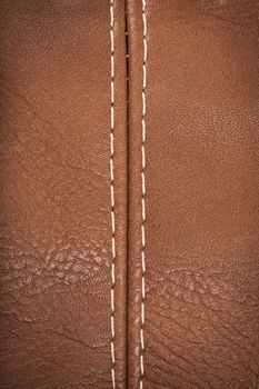 Closeup view of leather material jointed by stitch