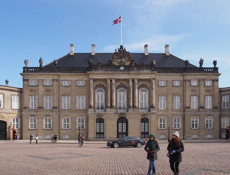 COPENHAGEN - MAR 16, 2013: Amalienborg, the winter home of the Danish royal family is located in Copenhagen, Denmark. It consists of four identical classicizing palace with rococo interiors.