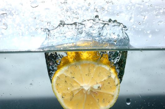 Fresh lemon splash into water