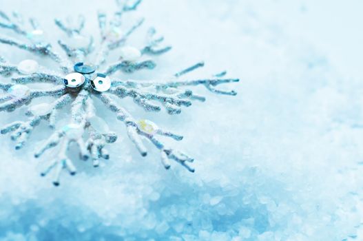 Frosty snowlake in snow Christmas decoration background