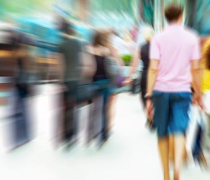 People rush on crowded street. Motion blur