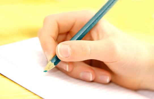 Close-up of child hand writing or drawing