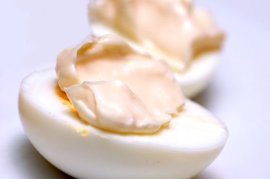 Eggs with mayonnaise on white plate