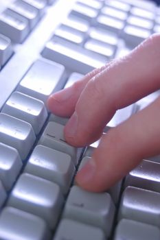 Typing on keyboard close up