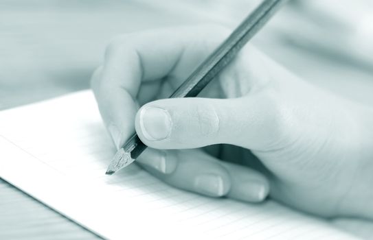 Close-up of child hand writing or drawing