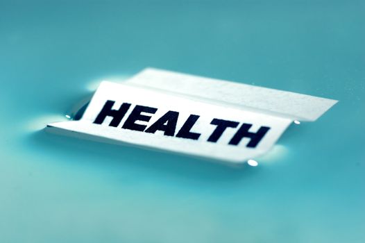 Card floating on water surface with printed word: HEALTH