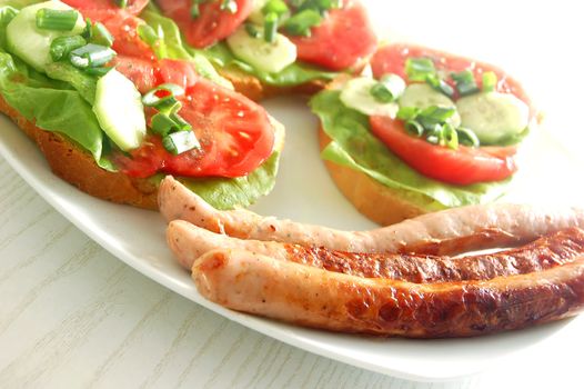 Plate with sandwiches and sausages