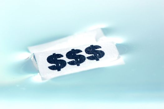 Card floating on water surface with printed: $$$