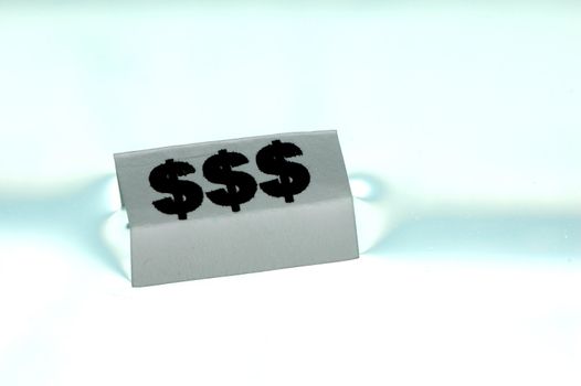 Card floating on water surface with printed: $$$