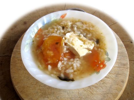 a bowl of porridge eith bean curd, tomato, seaweed, 