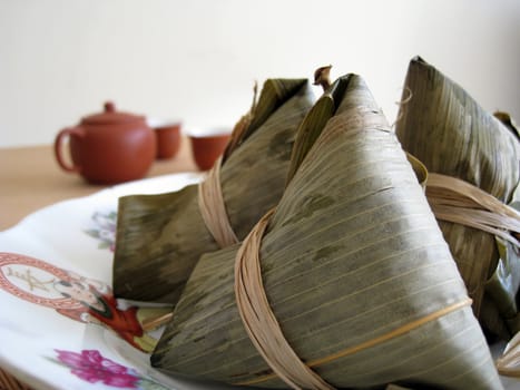 a pyramid-shaped mass of glutinous rice wrapped in leaves, one culture occasion in Chinese