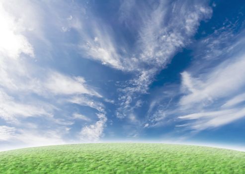 Beautiful nature background with green grass and blue vivid sky with clouds.