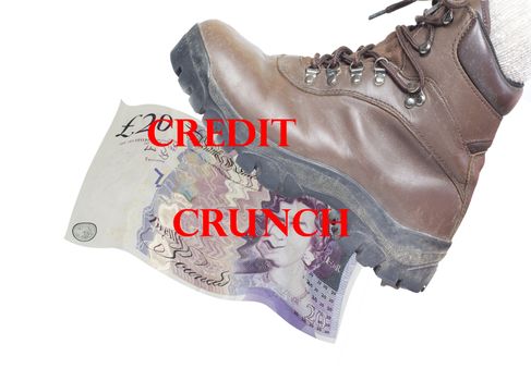 a boot  stamping and crunching a twenty pound note under its sole