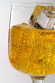 Glass of yellow drink with ice closeup (C1)