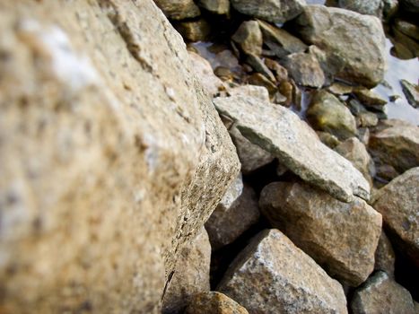 close up of rocks, with smaller rocks on the water