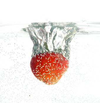Strawberry jumping into water