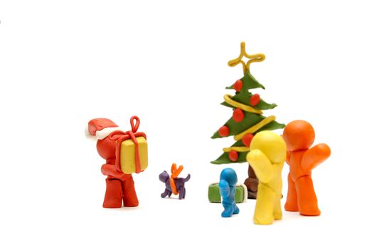 Plasticine figures staying together and celebrating christmas time, Santa Clous giving away presents