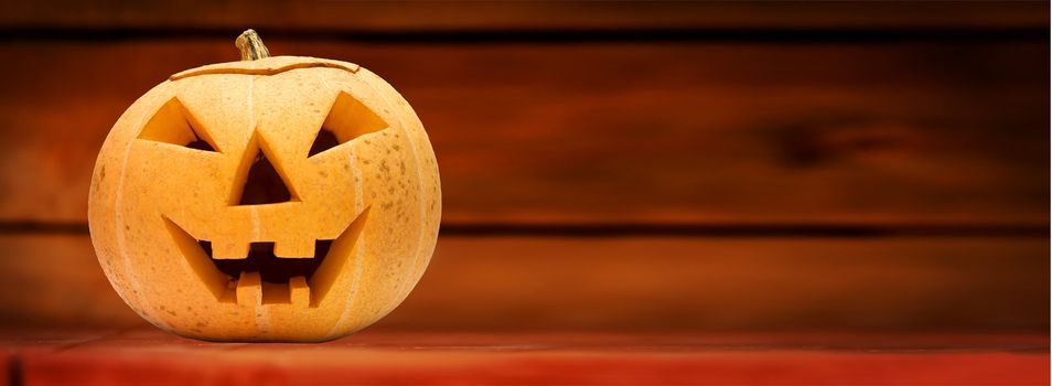 Halloween scary pumpkin face. Wooden background. Panoramic