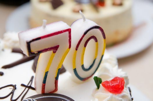 70 years old candles on a cream cake