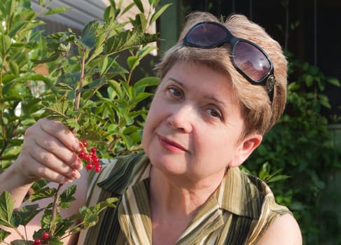 Woman with red currant berries