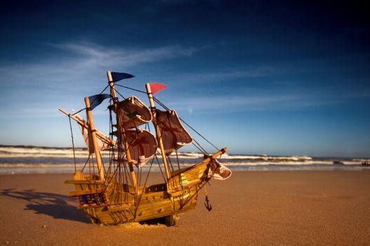 Ship model on summer sunny beach. Travel, voyage, vacation concepts