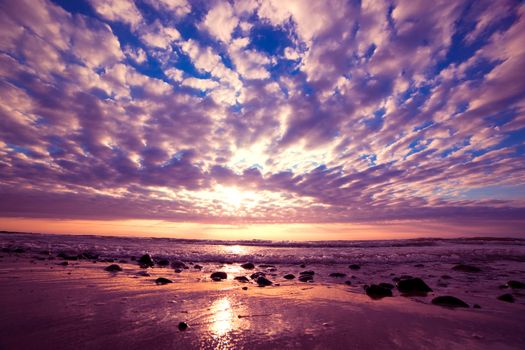 Romantic sunrise over ocean. Dramatic sky